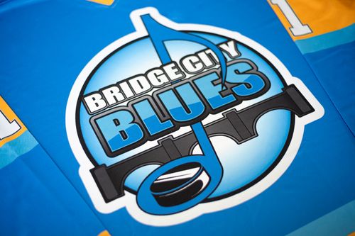 Saskatoon Bridge City Blues blue hockey jersey by Minuteman Press