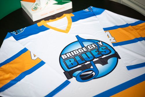 Saskatoon Bridge City Blues white hockey jersey by Minuteman Press